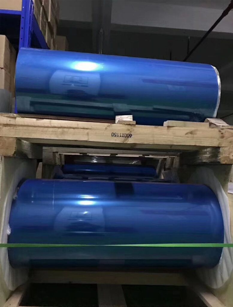 Large roll of blue PET protective film stored in warehouse at DCA Tape, professional protective film manufacturer in China, for electronic and industrial surface protection