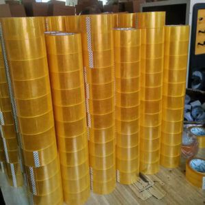 Heavy duty BOPP packing tape jumbo rolls stacked in warehouse, large volume industrial supply